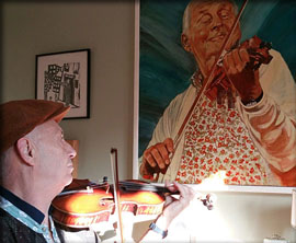 Jacques Gay devant le portrait de Stéphane Grappelli
